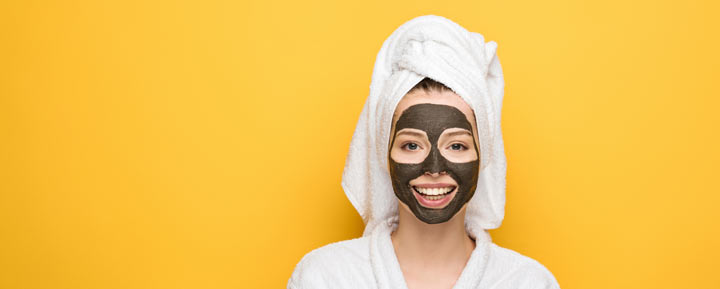 woman with a charcoal face mask