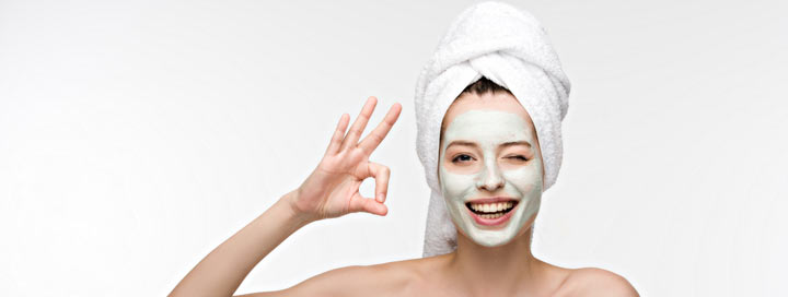 woman with a green clay face mask