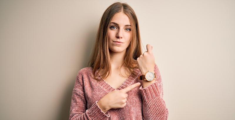woman pointing at her watch